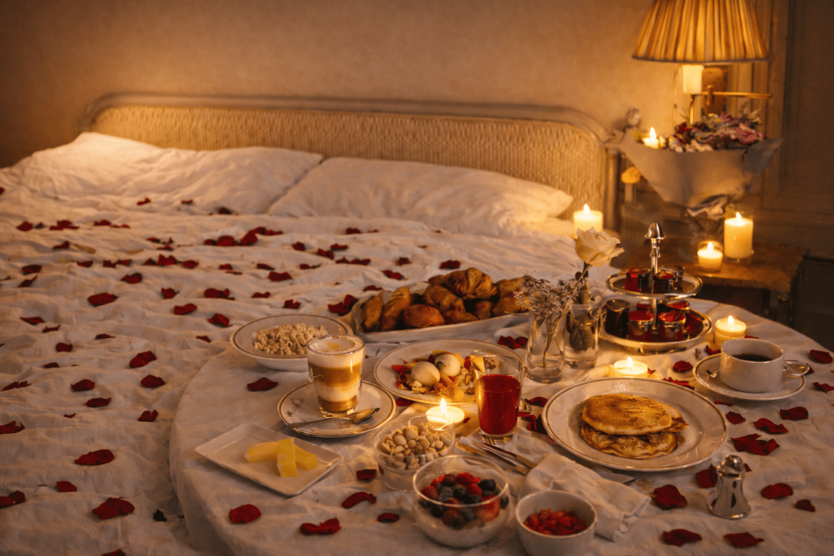 red rose petals scattered on bed and table 2 litres romantic breakfast valentines day